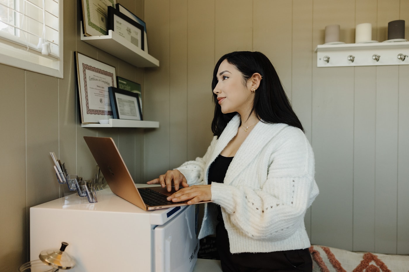 A small business owner updating her website from a laptop
