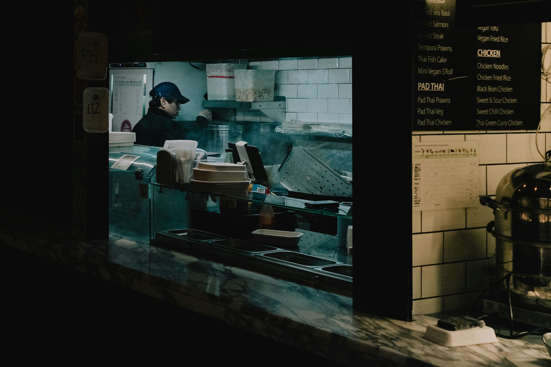 Independent restaurant operator working behind an open kitchen counter
