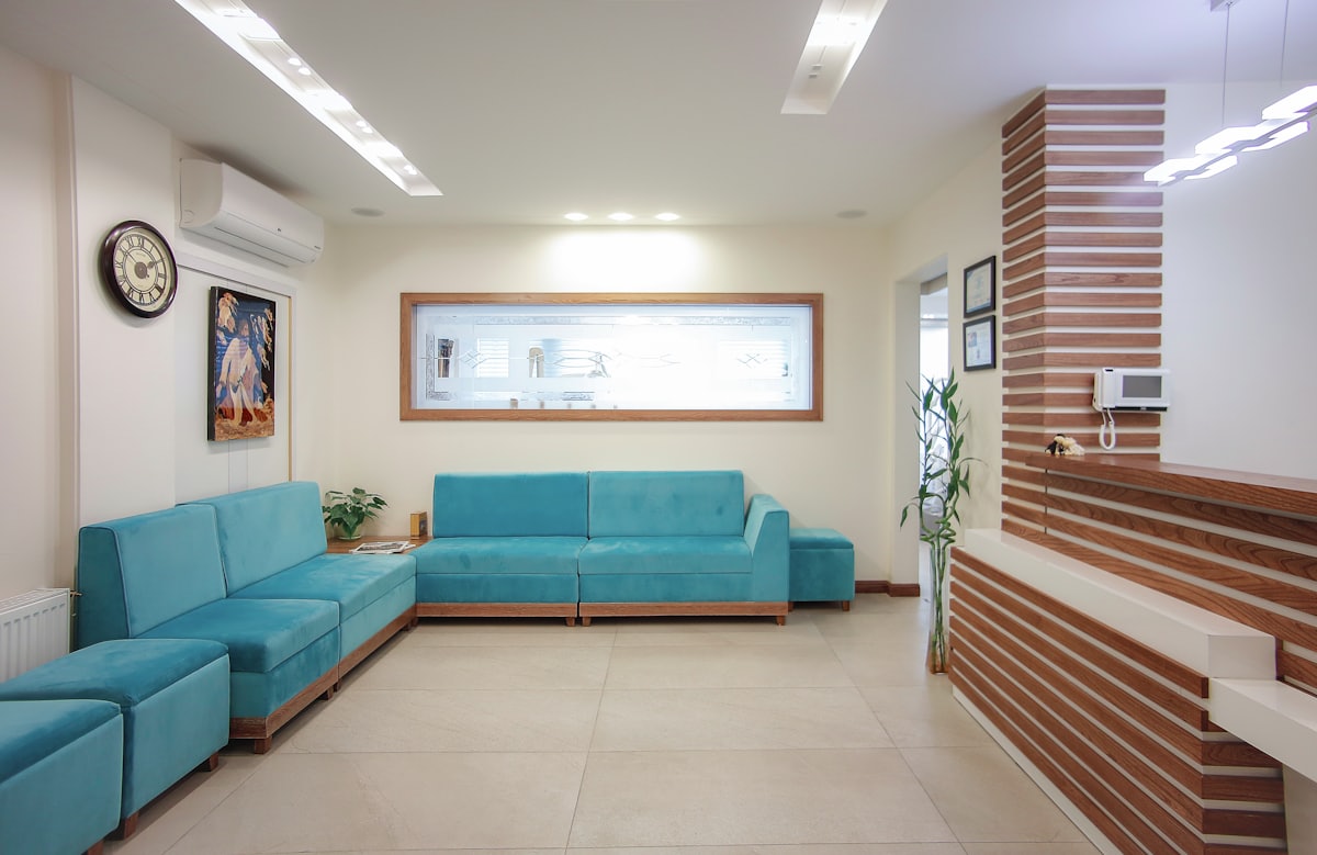 Bright clinic waiting room with a reception desk