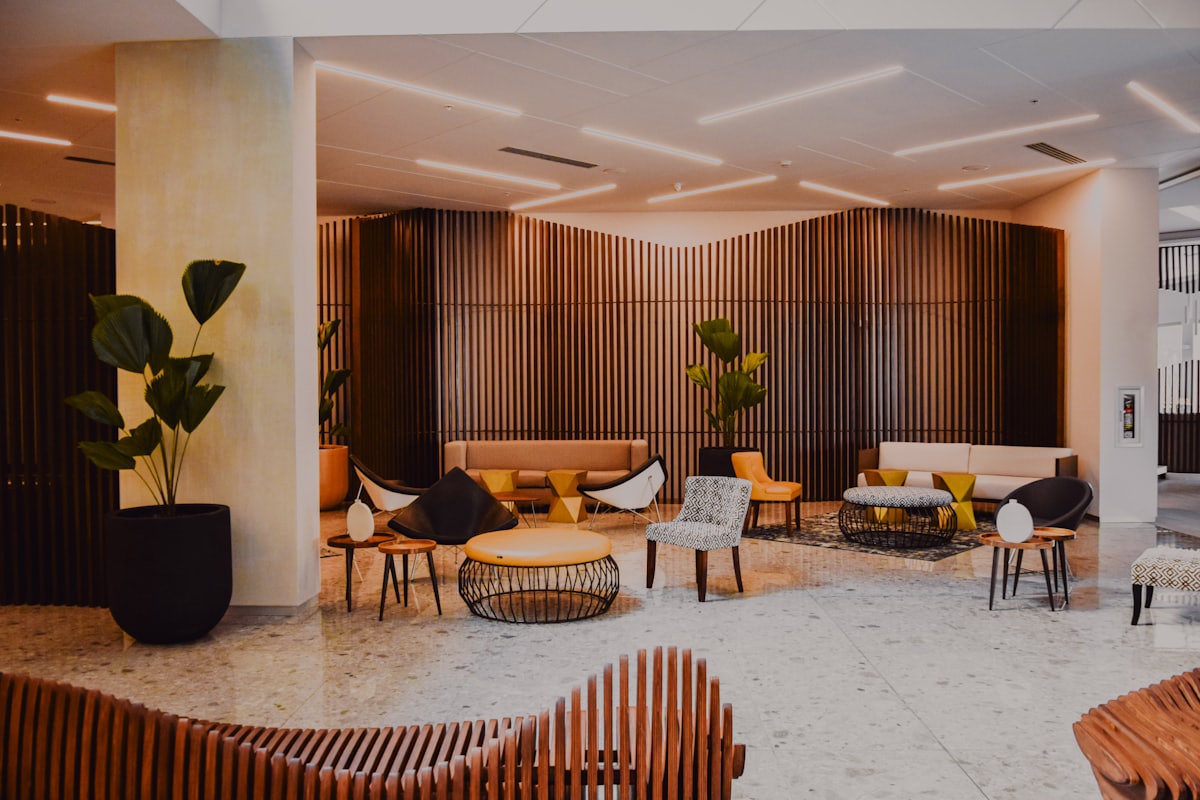 Contemporary hotel lobby with warm timber screening and lounge seating