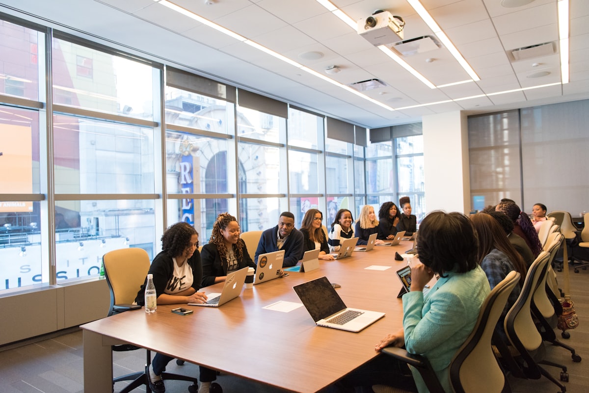 Team meeting around a boardroom table in a daylit office
